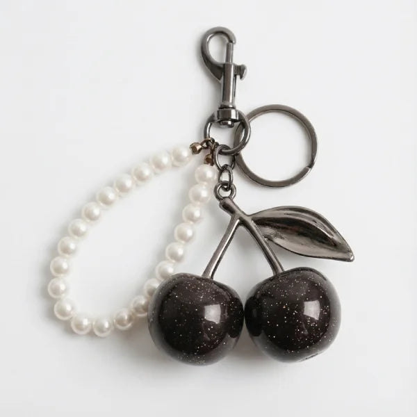 Keychain with cherries and pearl chain on a white background