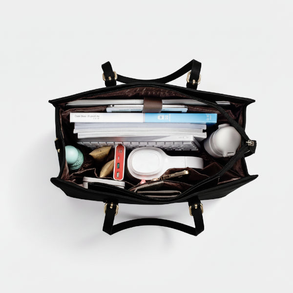 Interior view of Clea black polyester tote bag with multiple compartments, organized with a laptop, books, and accessories