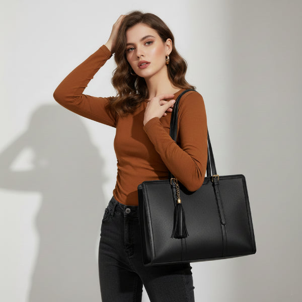Model carrying Clea black polyester tote bag with gold accents, dressed in a casual outfit with a beige trench coat and sneakers