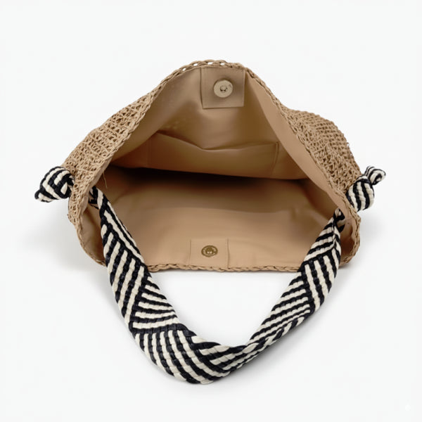 Interior of beige woven tote bag with neutral lining and button closure, offering a spacious design