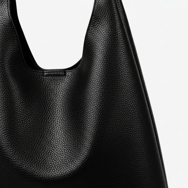 Close-up of Elaria vegan leather hobo bag in black with textured surface and smooth handle