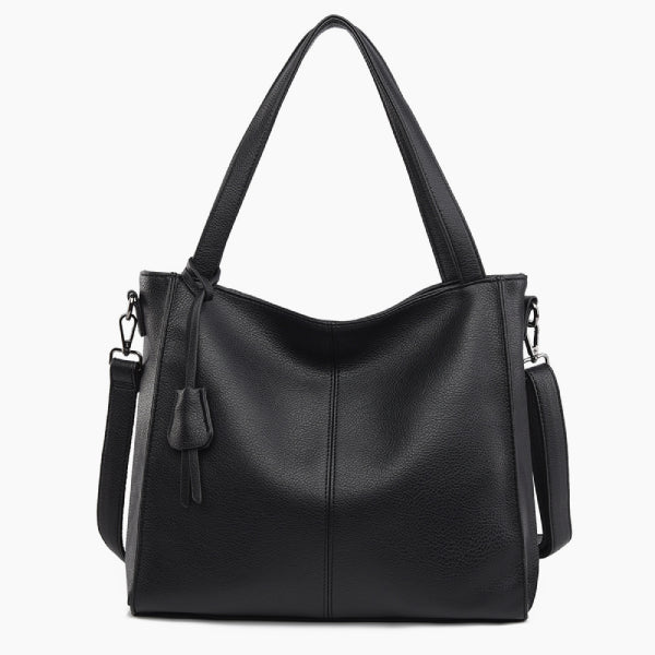 Front view of a black vegan leather tote bag with minimalist design, complemented by sturdy straps and a tassel detail