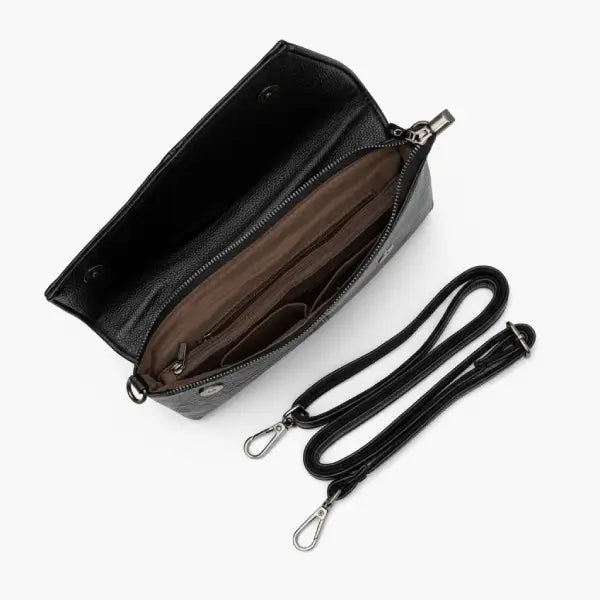 Interior of a black vegan leather satchel bag with a spacious compartment and multiple sections for organization