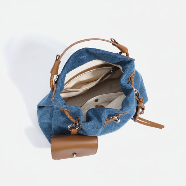 Evelisse Denim Bucket Bag in denim blue, top view of interior with zip pocket, slip compartments, and tan leather trim