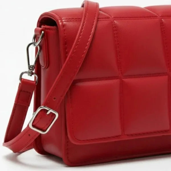 Isla Vegan Leather Crossbody Bag in red, closeup highlighting padded stitching, silver hardware, and detachable strap clip