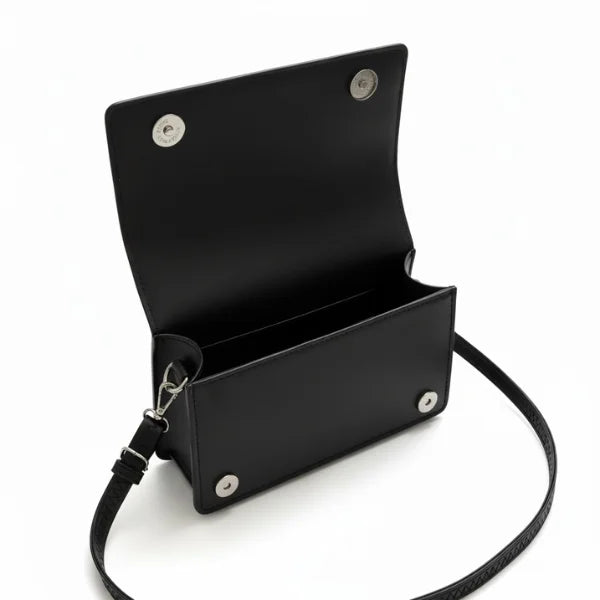 Isla Vegan Leather Crossbody Bag in black, open flap interior view with magnetic snap closure and slip pocket for essentials