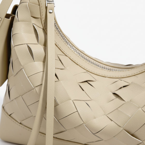Close-up of Ismara genuine leather woven hobo bag in beige, highlighting the intricate woven design and smooth finish