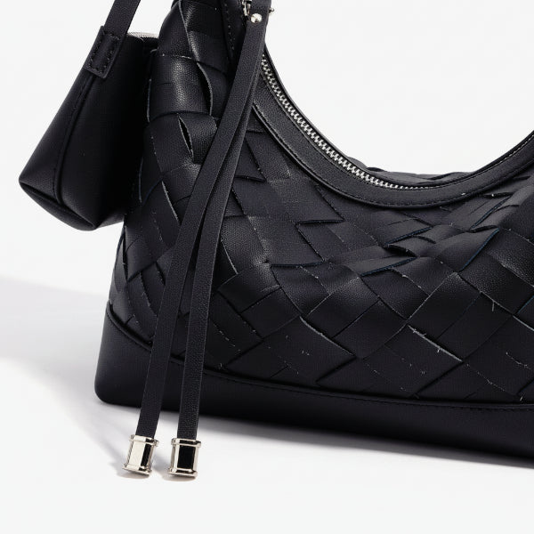 Close-up of Ismara genuine leather woven hobo bag in black, highlighting the intricate woven texture and sleek zipper detail
