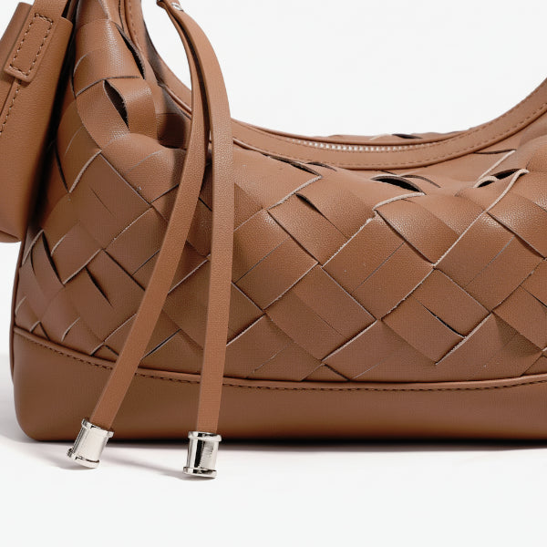 Close-up of Ismara genuine leather woven hobo bag in brown, showcasing the detailed woven leather texture and silver zipper details