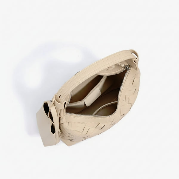Interior view of Ismara genuine leather woven hobo bag in beige, showcasing the spacious compartments and organized pockets