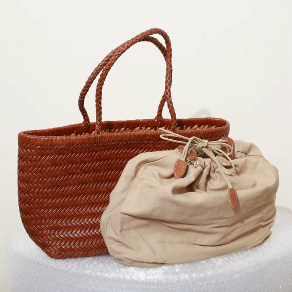 Interior view of a brown leather tote bag with a beige cloth insert pouch