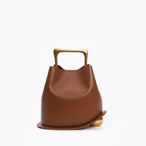 Front view of a Brown Izelia top grain leather crossbody bag with gold handle on a white background