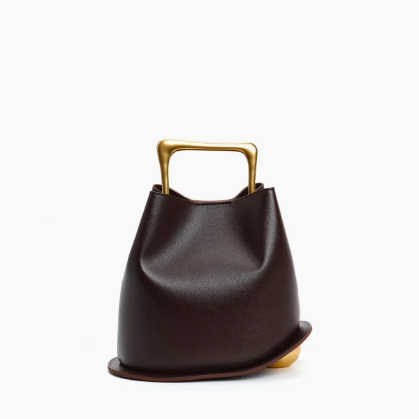 Front view of a Coffee Izelia top grain leather crossbody bag with gold handle on a white background