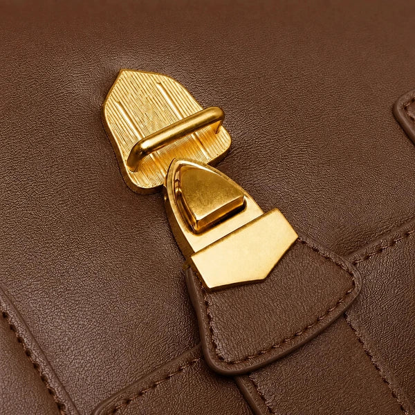 Lévoria Genuine Leather Satchel Bag in brown, close-up featuring a polished gold-tone metal clasp and stitched leather tab.