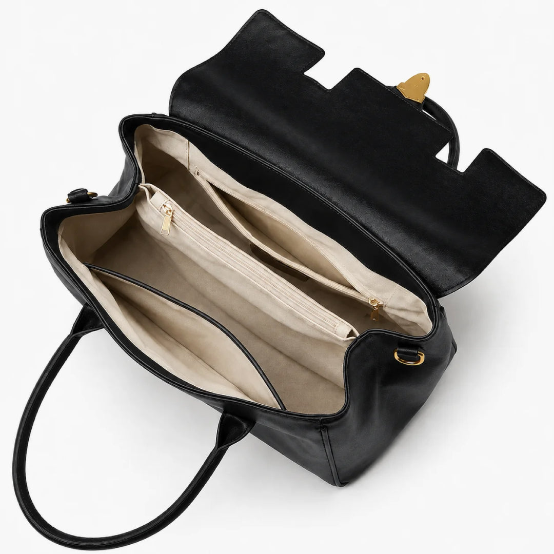 Black leather handbag shown open from above, revealing a beige interior with multiple zip compartments and gold-tone hardware on a white background.