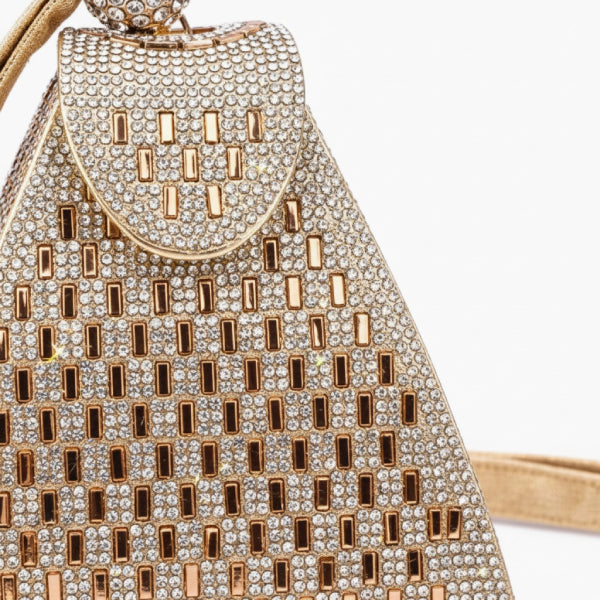 Liora Handmade Crystal Acrylic Evening Bag in gold, closeup highlighting champagne rhinestones, geometric pattern, and wrist strap