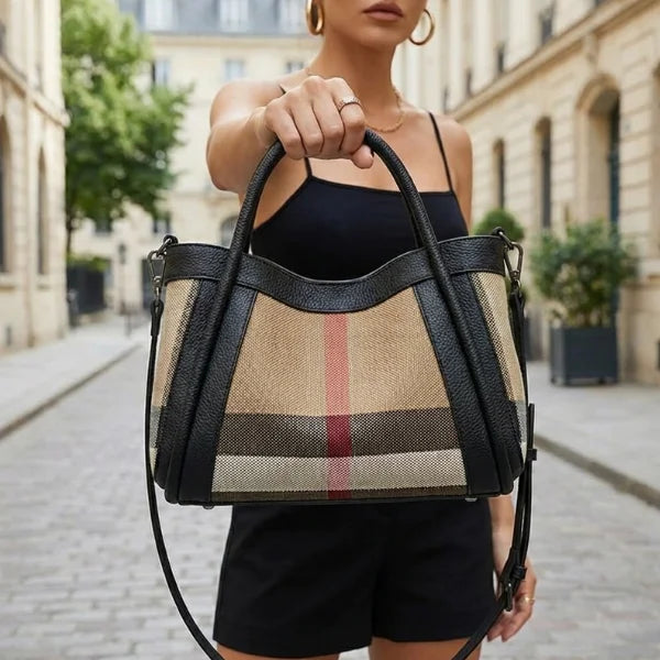 Person holding a checkered handbag on a city street