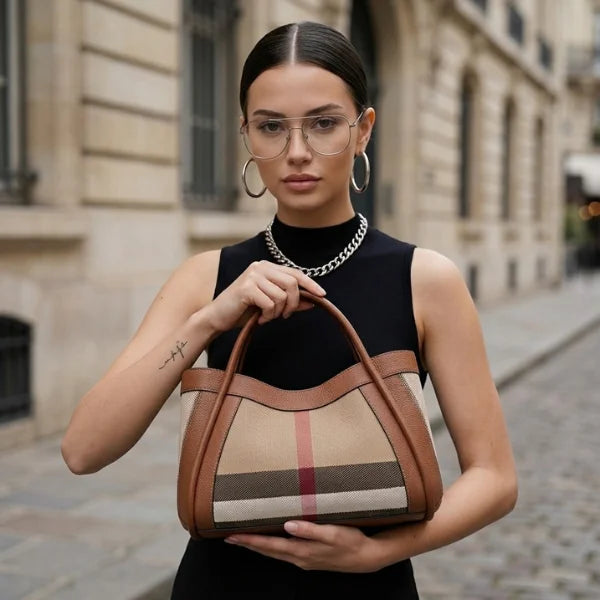 Woman holding a brown handbag on a city street