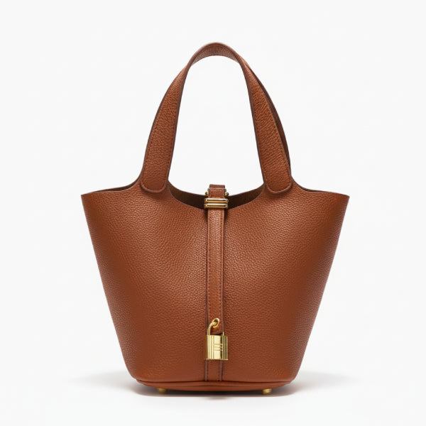 Lunelia Vegan Leather Bucket Bag in caramel, front studio view showcasing tapered bucket silhouette with twin handles and padlock charm