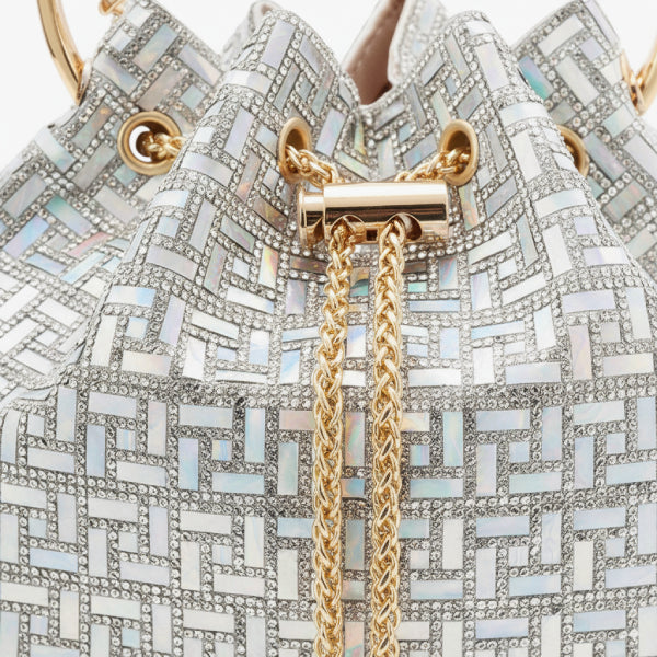 Lyanna Metallic Embellished Bucket Bag in silver, closeup highlighting mosaic shimmer, gold grommets, and chain drawstring tassels