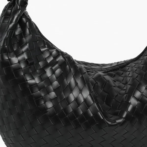 Maris Vegan Leather Hobo Bag in black, closeup highlighting soft woven texture and relaxed crescent shape