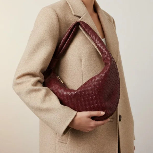 Maris Vegan Leather Hobo Bag in wine red, worn on the arm to showcase woven design and slouchy shape
