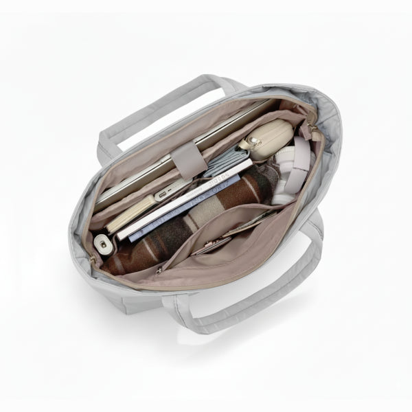 Interior view of grey puffer-style tote bag, showcasing its spacious compartments and organization for daily essentials