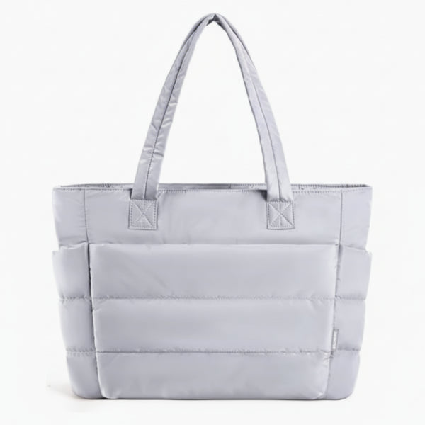 Front view of grey puffer-style tote bag with quilted texture and comfortable handles, ideal for everyday use
