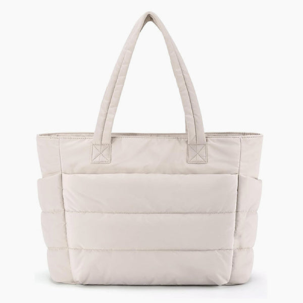 Front view of off-white puffer-style tote bag with soft quilted texture and durable handles for versatile use
