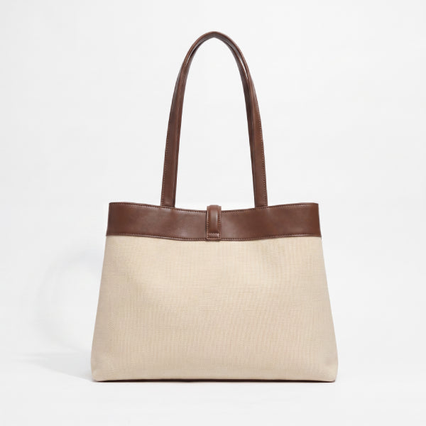A structured tote bag with a textured beige body and dark brown leather trim and handles, shown against a plain white background.
