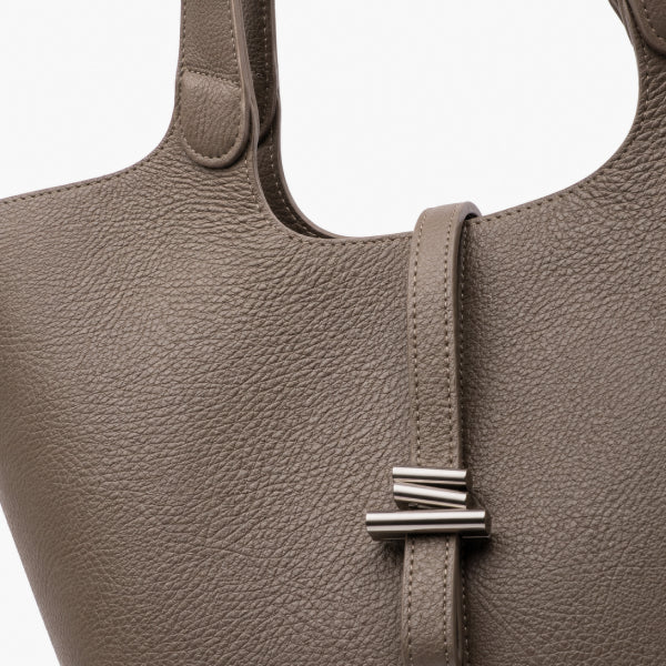 Montréa Genuine Leather Tote Bag in taupe, close-up with a silver-toned metal bar detail on the front strap