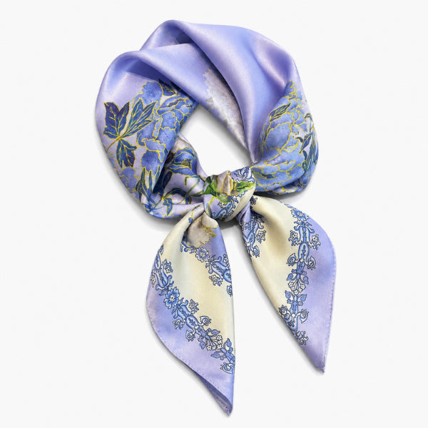 Floral patterned scarf tied into a knot on a white background