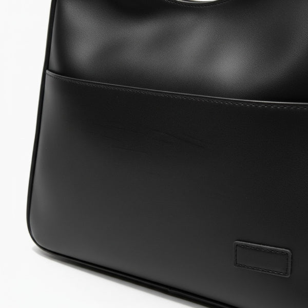 Closeup of Seliora vegan leather shoulder bag in black color with front pocket and minimalist design