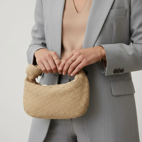 Seraphine Vegan Leather Hobo Bag in apricot, lifestyle shot with model holding the mini woven hobo highlighting elegant everyday style