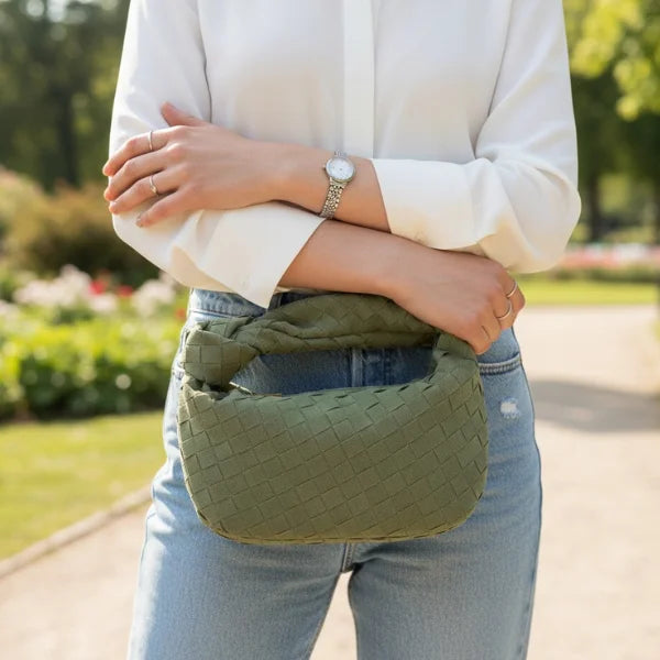 Seraphine Vegan Leather Hobo Bag in green, lifestyle outdoor shot with model in white shirt showcasing casual mini woven hobo