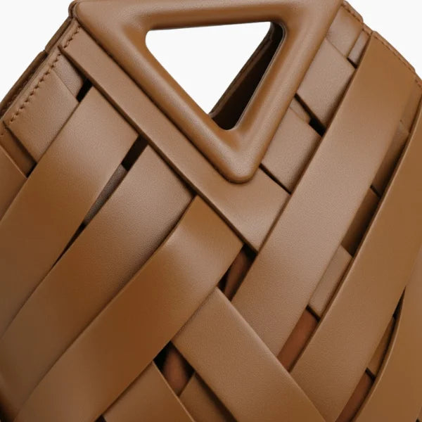 Seren Vegan Leather Bucket Bag in brown, closeup highlighting triangular top handle and wide woven straps