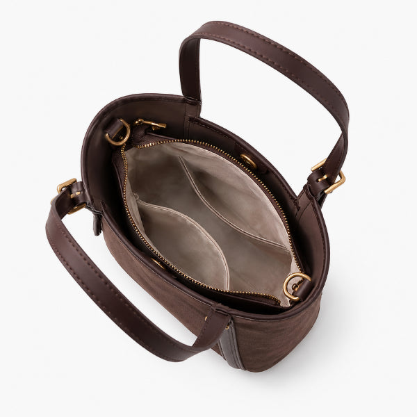 A dark brown leather handbag shown open from an overhead angle, revealing a light beige interior with two zip compartments and gold-tone hardware.