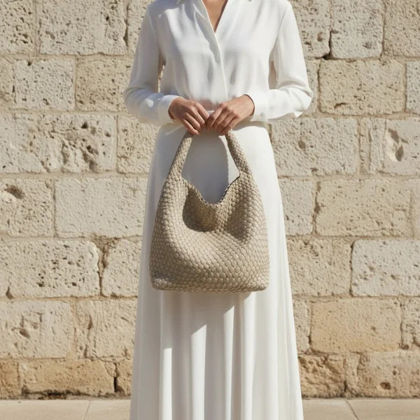 Soraya Vegan Leather Hobo Bag in off-white, lifestyle shot with model showcasing large woven shoulder hobo for elegant everyday style