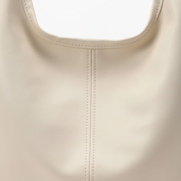 Sorella Vegan Leather Hobo Bag in off-white, close-up of smooth vegan leather with soft drape and center seam