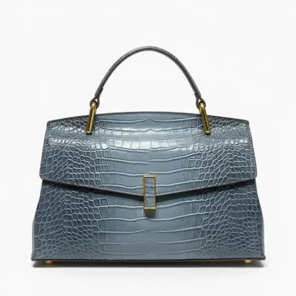 Front view of blue crocodile leather satchel bag featuring a gold clasp and glossy textured finish