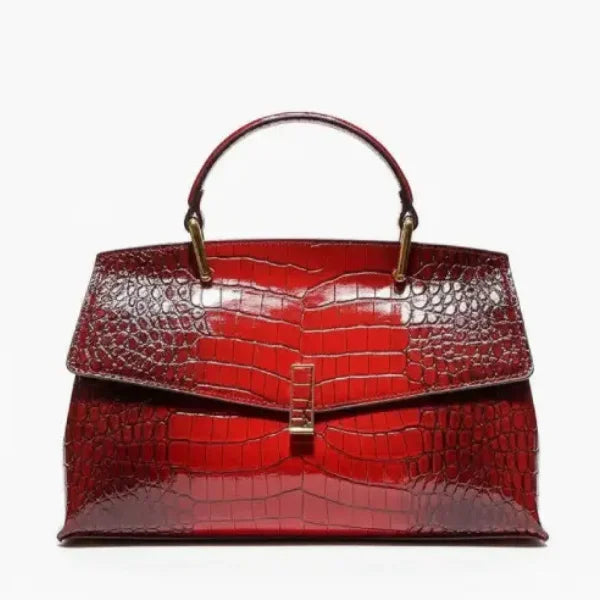 Front view of red crocodile leather satchel bag featuring a gold clasp and glossy textured finish