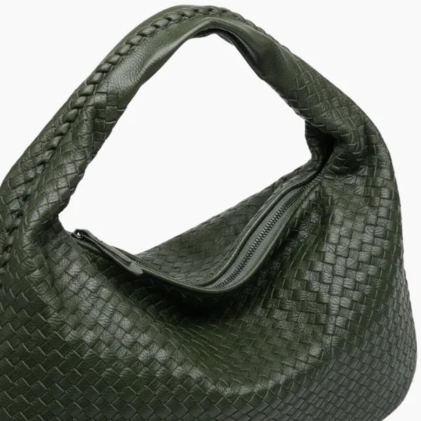 Close-up of dark green woven vegan leather hobo bag with zipper closure and braided handle detail