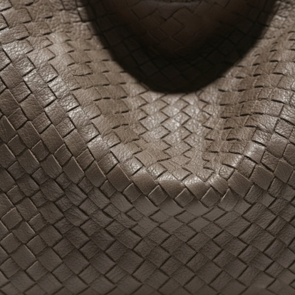 Close-up of grey woven vegan leather hobo bag showing intricate weave pattern and smooth texture