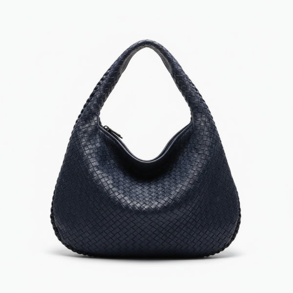 Front view of dark blue woven vegan leather hobo bag with a structured design, wide handle, and zipper opening