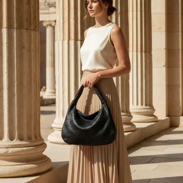 Valencia Vegan Leather Hobo Bag in black, model holding woven crescent hobo to showcase elegant everyday style