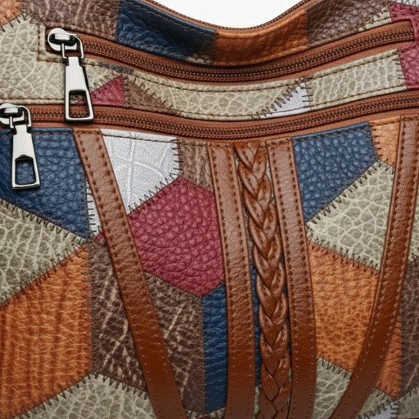 Vera Vegan Leather Crossbody Bag in brown, closeup of textured patchwork leather with braided trim and metal zipper pulls