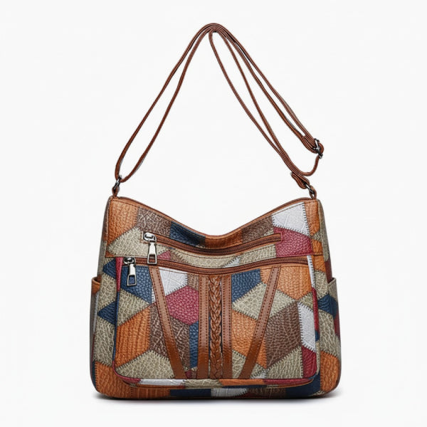 Vera Vegan Leather Crossbody Bag in brown, front studio view showcasing front zip pockets, side slip pockets, and curved top