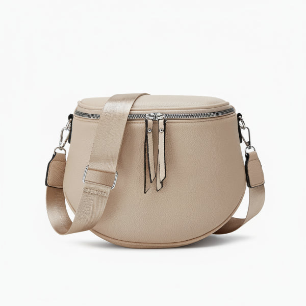 Front view of an apricot vegan leather crossbody bag with round shape, double zipper closure, and adjustable strap