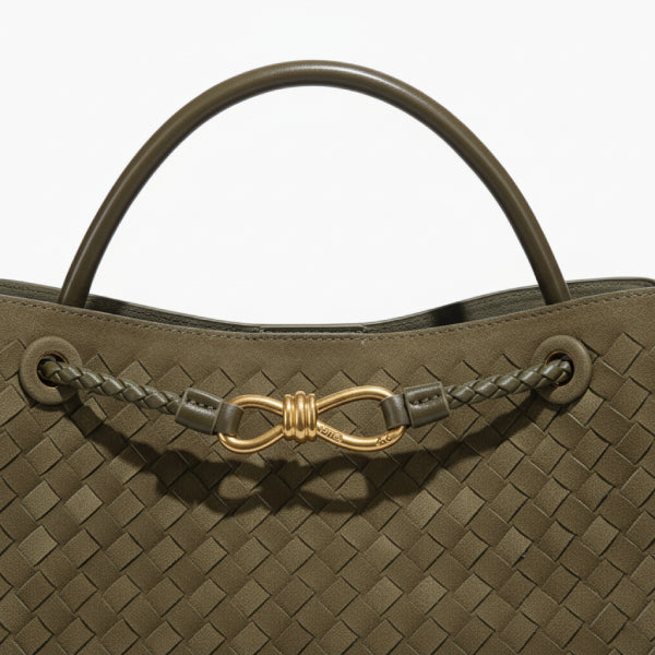 Close-up of the Veyra vegan leather tote bag in green, featuring the elegant braided leather strap and gold-tone knot closure