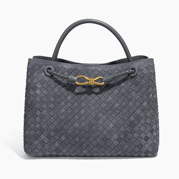 Front view of the Veyra vegan leather tote bag in gray, showcasing its sophisticated woven texture and luxurious gold-tone knot accent